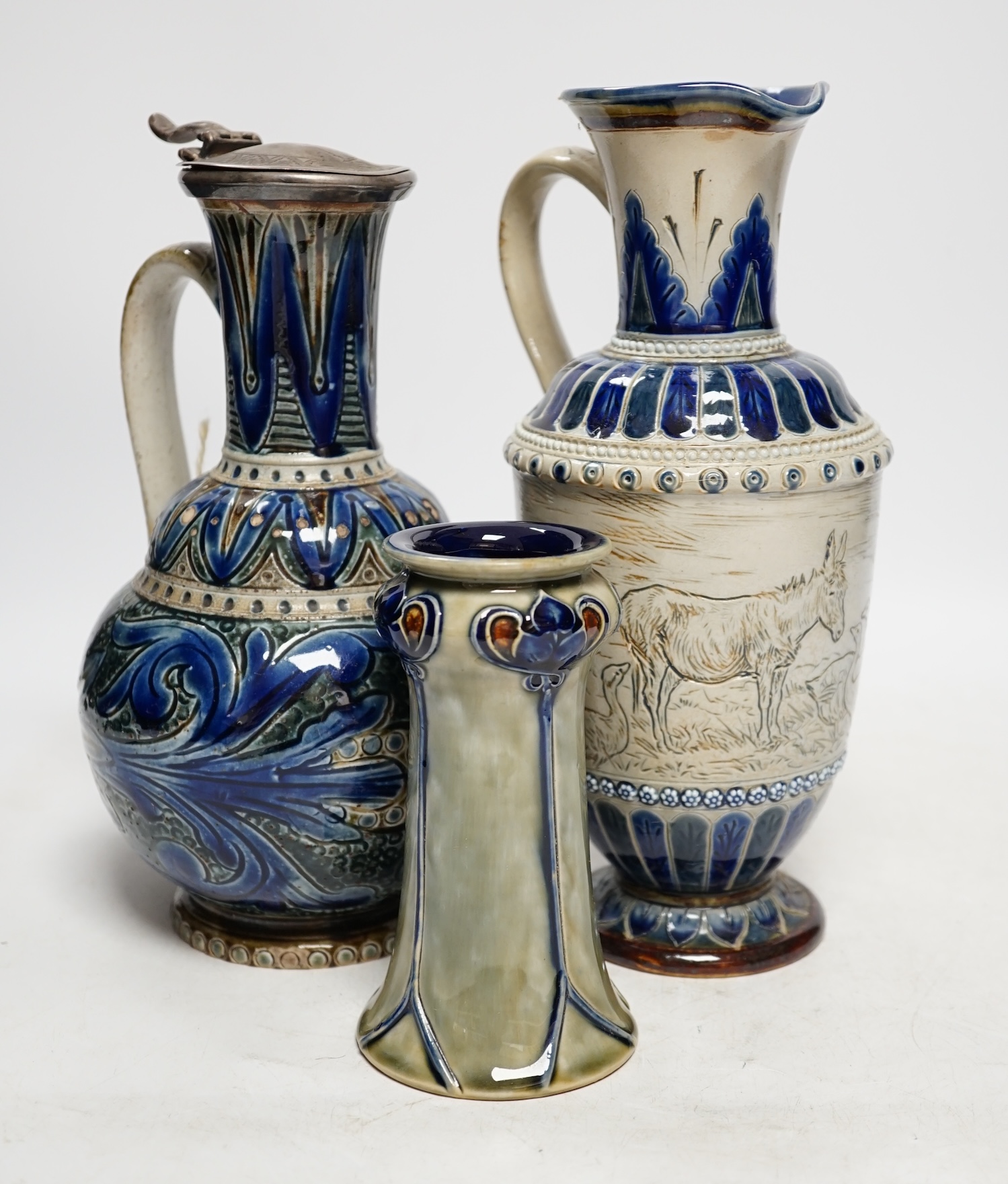 A Hannah Barlow for Doulton ‘geese and donkey’ jug, another jug dated 1874 and a small Royal Doulton vase, largest 24cm high. Condition - good